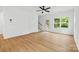 A bright and airy living room with a ceiling fan, a back door to the porch, and natural light at 3924 Hager Dr, Charlotte, NC 28208