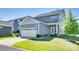 The back exterior features a two-car garage, a well-maintained lawn, and pleasing architectural elements at 4051 Whittier Ln, Fort Mill, SC 29708