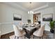 Elegant dining room featuring modern chandelier, stylish table setting, and neutral decor creating a welcoming ambiance at 4051 Whittier Ln, Fort Mill, SC 29708