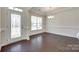 Inviting foyer with elegant glass door and chandelier, and hardwood floors creates a lasting first impression at 4051 Whittier Ln, Fort Mill, SC 29708