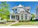 Charming two-story home boasts a stone facade, inviting porch, and well-manicured lawn, perfect for curb appeal at 4051 Whittier Ln, Fort Mill, SC 29708