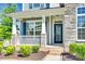 Charming home exterior featuring a covered front porch with stone accents and manicured landscaping at 4051 Whittier Ln, Fort Mill, SC 29708