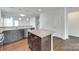 Modern kitchen with a central island featuring granite countertops, stainless steel appliances, and stylish wood cabinets at 4051 Whittier Ln, Fort Mill, SC 29708