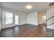 Spacious living room with hardwood floors, a glass panel back door, and neutral walls at 4051 Whittier Ln, Fort Mill, SC 29708