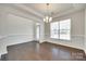 A bright living room with hardwood floors, a decorative chandelier, and large window with lots of natural light at 4051 Whittier Ln, Fort Mill, SC 29708