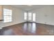 Bright living room features hardwood floors, a back door, and large windows, allowing for natural light at 4051 Whittier Ln, Fort Mill, SC 29708