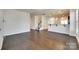 Open-concept living room with hardwood floors, a staircase, and a kitchen featuring a breakfast bar at 4051 Whittier Ln, Fort Mill, SC 29708