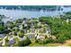 Aerial view showcases waterfront homes near a lake, surrounded by lush greenery and mature trees at 4431 1St Street Nw Dr, Hickory, NC 28601