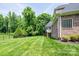 A spacious backyard with a well-manicured lawn and a partial view of the brick home at 4431 1St Street Nw Dr, Hickory, NC 28601