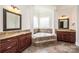 A luxurious bathroom showcases a soaking tub, dual vanities, and tile flooring at 4431 1St Street Nw Dr, Hickory, NC 28601
