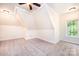 A well-lit bedroom featuring neutral carpet, a ceiling fan, and a window providing natural light at 4431 1St Street Nw Dr, Hickory, NC 28601
