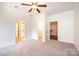 Spacious carpeted bedroom with white trim, ceiling fan, and access to other rooms through doorways at 4431 1St Street Nw Dr, Hickory, NC 28601
