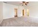 Bright bedroom with neutral carpet, white trim, ceiling fan, and multiple doorways to other rooms at 4431 1St Street Nw Dr, Hickory, NC 28601