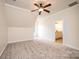 Bedroom featuring a neutral carpet, white trim, a ceiling fan, and an open door to a bathroom at 4431 1St Street Nw Dr, Hickory, NC 28601