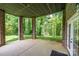 Covered brick patio overlooking a serene, wooded backyard offers a relaxing outdoor space at 4431 1St Street Nw Dr, Hickory, NC 28601