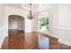 Formal dining room featuring hardwood floors, an elegant chandelier, and a large arched window at 4431 1St Street Nw Dr, Hickory, NC 28601