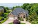 Impressive stone home with a three-car garage, manicured landscaping, and a paver driveway at 4431 1St Street Nw Dr, Hickory, NC 28601