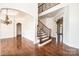 Elegant foyer with hardwood floors, a staircase with iron railings, and an open archway at 4431 1St Street Nw Dr, Hickory, NC 28601