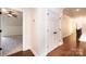 A hallway with wood flooring leads to a bedroom and closet, showcasing trim and bright lighting at 4431 1St Street Nw Dr, Hickory, NC 28601