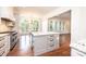 A bright kitchen featuring a large island, granite countertops, and stainless steel oven and cooktop at 4431 1St Street Nw Dr, Hickory, NC 28601