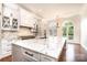 An open kitchen offers granite countertops, custom cabinets, arched windows and a large island with bar seating at 4431 1St Street Nw Dr, Hickory, NC 28601