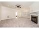 A cozy living room features a fireplace, large windows, and neutral carpet at 4431 1St Street Nw Dr, Hickory, NC 28601