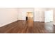 Open-concept living area showcasing hardwood flooring, white trim, and kitchen access at 4431 1St Street Nw Dr, Hickory, NC 28601