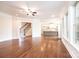 Well-lit living room with hardwood flooring, stairs, and view of the kitchen with island at 4431 1St Street Nw Dr, Hickory, NC 28601