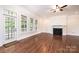 Bright living room featuring hardwood floors, fireplace, and multiple windows allowing natural light at 4431 1St Street Nw Dr, Hickory, NC 28601