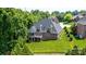 Back exterior view featuring a screened porch and a lush, well-maintained lawn surrounded by mature trees at 4431 1St Street Nw Dr, Hickory, NC 28601