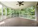 Large screened porch overlooking lush greenery, perfect for outdoor relaxation and entertainment at 4431 1St Street Nw Dr, Hickory, NC 28601