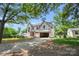 New construction home featuring a two-story design with an attached garage in a wooded location at 4918 Buckingham Dr, Charlotte, NC 28209