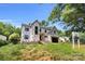 Front view of a new construction home with large windows, a covered entry, and landscaping potential at 4918 Buckingham Dr, Charlotte, NC 28209