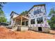 Rear exterior of a new construction home with a covered porch and large windows, set on a spacious lot at 4918 Buckingham Dr, Charlotte, NC 28209