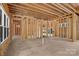 Unfinished living space featuring exposed studs, beams, and multiple windows offering ample natural light at 4918 Buckingham Dr, Charlotte, NC 28209
