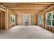 Unfinished living space with exposed studs, beams, and multiple windows offering ample natural light at 4918 Buckingham Dr, Charlotte, NC 28209
