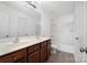 Bathroom featuring double sink vanity with wood cabinets and a shower-tub combo at 5008 Social Cir, Fort Mill, SC 29707