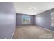 Bedroom featuring a large window, neutral carpet and lavender paint at 5008 Social Cir, Fort Mill, SC 29707