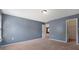Spacious bedroom with neutral carpet, blue walls, and a doorway to a walk-in closet at 5008 Social Cir, Fort Mill, SC 29707