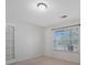 Neutral bedroom boasts a double window, a light fixture, and a door leading to a walk-in closet at 5008 Social Cir, Fort Mill, SC 29707