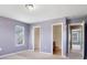 Bedroom with a large window, neutral carpet, three doors, and lavender walls at 5008 Social Cir, Fort Mill, SC 29707