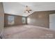 Spacious primary bedroom featuring two windows, neutral carpet, ceiling fan, and vaulted ceiling at 5008 Social Cir, Fort Mill, SC 29707