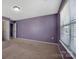 Bedroom featuring a large window, neutral carpet and lavender paint at 5008 Social Cir, Fort Mill, SC 29707