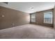 Bright bedroom featuring plush carpeting and two windows offering ample natural light at 5008 Social Cir, Fort Mill, SC 29707