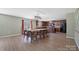 A dining room boasts wood floors, an elegant light fixture and a window with light from outdoors at 5008 Social Cir, Fort Mill, SC 29707