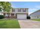 Charming two-story home featuring a well-manicured lawn, stone accents, and a convenient two-car garage at 5008 Social Cir, Fort Mill, SC 29707