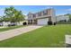 Inviting two-story home showcasing a lush green lawn and a spacious driveway leading to a two-car garage at 5008 Social Cir, Fort Mill, SC 29707
