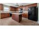 Well-equipped kitchen boasts wood cabinets, stainless steel appliances, and a center island at 5008 Social Cir, Fort Mill, SC 29707