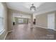 Open living room provides ample space with wood floors, view of the fireplace, and access to multiple rooms at 5008 Social Cir, Fort Mill, SC 29707