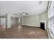 Open-concept living room featuring fireplace, wood floors, and abundant light at 5008 Social Cir, Fort Mill, SC 29707